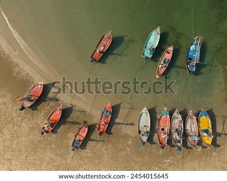 Aerial shot of a tranquil body of water with several boats floating on the surface
