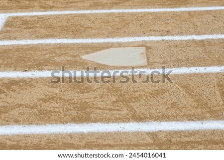 extreme close up of a softball field home plate and the batters box