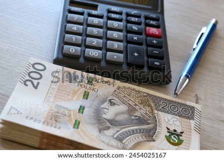 Polish banknotes spread out on the desk, PLN 100, PLN 200, PLN 500