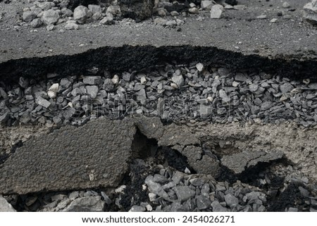 Asphalt road cross section in repair and reconstruction work. To show layer of surface and underground material. asphalt concrete, bitumen, soil, sand, rock, stone, crust, ground and earth. earthquake Royalty-Free Stock Photo #2454026271