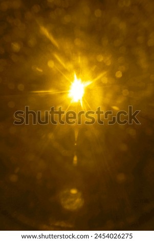 shiny sun, sunbeams, sunrays, sunshine design. yellow, orange  light effect, sun rays, golden beams isolated on black background. star dust. Sun flare on the dark space backdrop