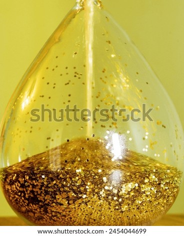 Glass hourglass with golden sand. The passage of time - concept