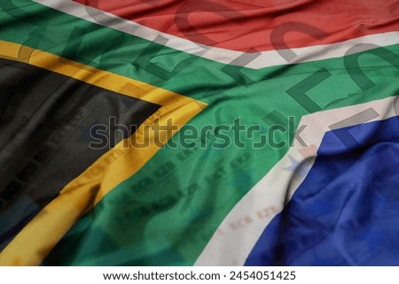 waving colorful national flag of south africa on a euro money banknotes background. finance concept. macro shot