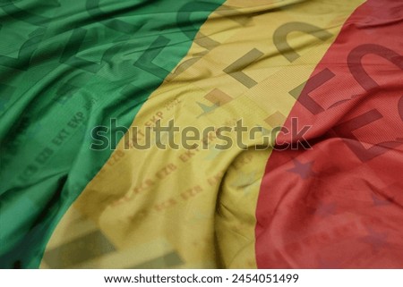 waving colorful national flag of republic of the congo on a euro money banknotes background. finance concept. macro shot