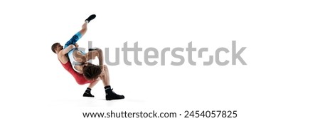 Athletes in motion, concentrated men, athletes, wrestlers in motion, training isolated on white background. Concept of combat sport and martial arts, competition,. tournament, athleticism. Banner