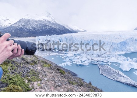 A person is taking a picture of Perito Moreno glacier in Patagonia, Argentina.