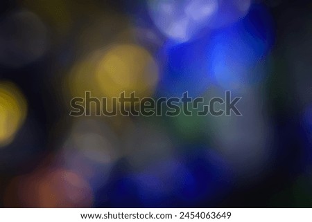 Defocused neon light. Overlay of light highlights. Futuristic abstract LED backlight. Neon colors blur on dark abstract background