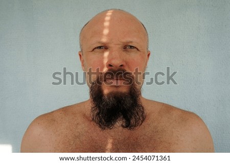 Men's beard. The guy's face is large. Brutal macho. Mustache and beard. Barber. Lumberjack. Portrait of a handsome man with a beard                                Royalty-Free Stock Photo #2454071361
