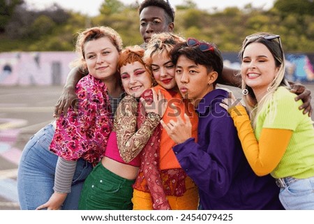 Happy multiracial people having fun together outdoor - Group of diverse friends taking a picture at park