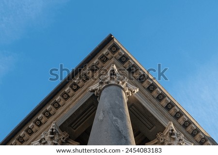 neoclassical column and capital rise towards the sky. Architecture that enhances the classical canons, with all the canonical elements of design and academic study. art and beauty of symmetry. Royalty-Free Stock Photo #2454083183
