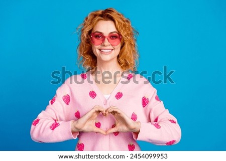 Photo portrait of lovely young lady sunglass heart gesture dressed stylish pink clothes isolated on blue color background