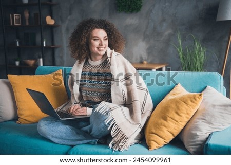 Photo of charming lovely dreamy woman sitting on soft sofa in cosy apartment indoors holding netbook Royalty-Free Stock Photo #2454099961