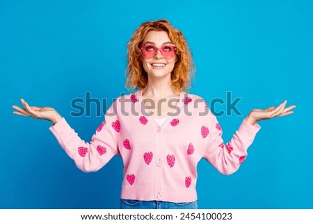 Photo of lovely young lady touch sunglass compare look empty space dressed stylish pink clothes isolated on blue color background