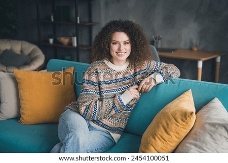 Photo of charming lovely cute woman dressed stylish clothes sitting in cozy apartment daylight indoors Royalty-Free Stock Photo #2454100051