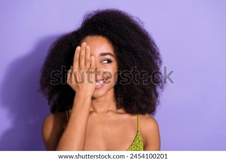 Photo portrait of gorgeous young girl palm cover eye look empty space wear trendy green sequins outfit isolated on purple color background