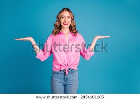 Photo portrait of pretty young girl compare empty space wear trendy pink outfit hairdo isolated on blue color background