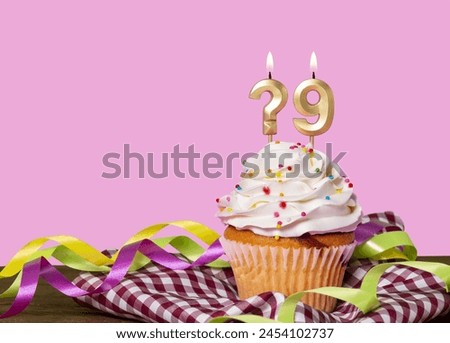 Birthday Cake With Candle Question Mark And Number 9 - Photo On Pink Background.