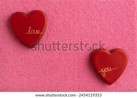 Two heart shaped cookies on pink background. Copy space. Love you. Valentines Day