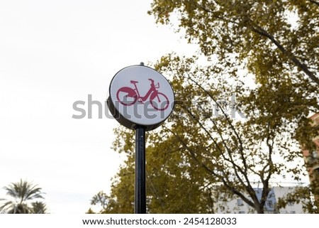 Sign indicating lane for bicycle traffic with trees in the background. Concept of transportation