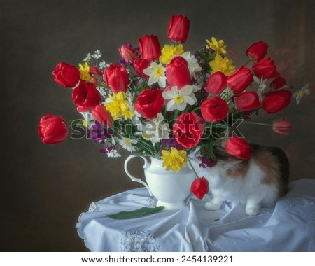 Bouquet of spring flowers and curious kitty