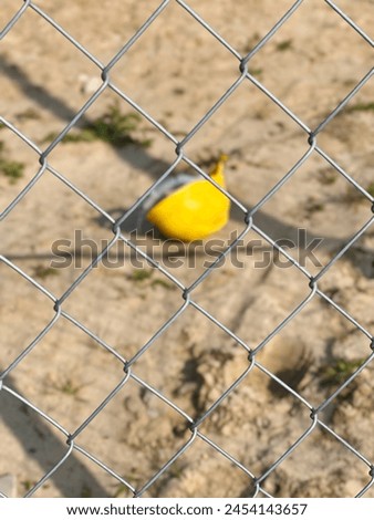 Yellow helmet left behind, lost safety helmet on the construction site, entry prohibited, do not enter, risk of damage to health abandoned protective headgear, misplaced safety equipment, forgotten  Royalty-Free Stock Photo #2454143657