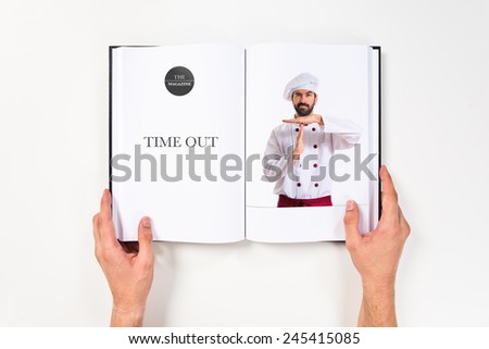 Chef making time out gesture printed on book