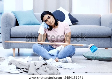 Woman, bored and portrait in living room for cleaning in house with sweeping, dirty clothes and broom. Annoyed, frustrated and moody from housework in home with unhappy for duties on weekend. Royalty-Free Stock Photo #2454151291