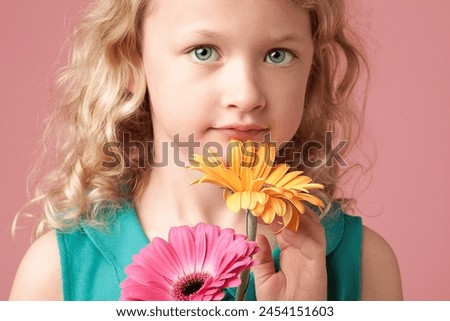 Portrait, child or girl with flowers by pink background for birthday picture, celebration or memory with plants. Studio, kid and barberton daisy with different color, floral and decoration by mockup