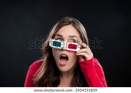 Woman, 3d glasses and surprise for watching movie, shocked or surreal in black studio background. Female person, wow and futuristic with color lens eyewear in cinema for mystery, film or mockup