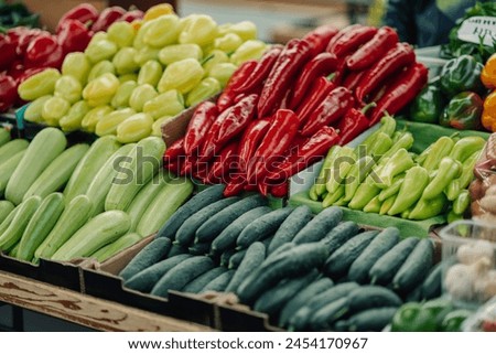 Cropped picture of many fresh organic vegetables in crates at farmers market with no people. Raw organic healthy products only. Photo of various vegan organic products on market stall at green market.