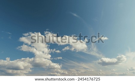 Floating Fluffy Clouds. Beautiful Sunny Blue Sky With Wispy Smoky White Clouds On Different Layers. Royalty-Free Stock Photo #2454176725