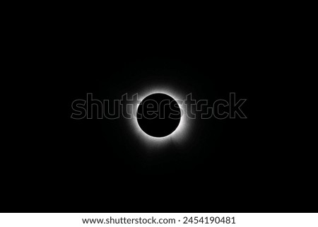 Total solar eclipse during totality near Mount Ida, Arkansas on April 8, 2024.  Solar prominences can be seen at the edge of the black moon with the corona emanating out
 Royalty-Free Stock Photo #2454190481