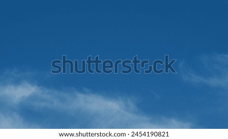 Angel wing shaped cloud against blue heaven. Cirrus clouds in blue sky. Panoramic skyscape. Time lapse.