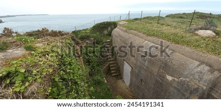 The blockhouse of Pointe du Grouin is a relic from World War II located on the Brittany coast, France. This blockhouse, constructed by the Germans during the occupation, is part of the coastal fortifi Royalty-Free Stock Photo #2454191341