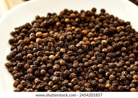 Explore the world of flavors with our high-quality photo of fresh black pepper. Black pepper, a staple spice in kitchens worldwide, adds depth and aroma to culinary creations. Known for its distinctiv