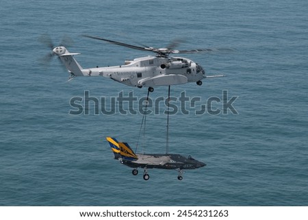 U.S. Marines flying a CH-53K King Stallion heavy-lift helicopter transported an F-35C Lightning II airframe from the F-35 Integrated Test Force at Patuxent River Royalty-Free Stock Photo #2454231263