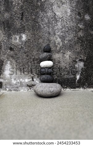 Exterior pgoto view of a lose up of a pile of stone pebbles rouns shape pile together one above the other one good balance harmony meditation yoga precise perfection perfect rocks zen