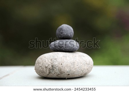 Exterior pgoto view of a lose up of a pile of stone pebbles rouns shape pile together one above the other one good balance harmony meditation yoga precise perfection perfect rocks zen