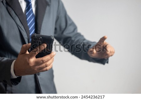 Businessman using a smartphone on a white background