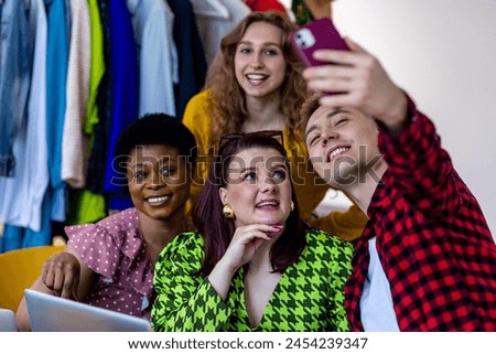 Concept of diversity, friendship between men and women, spending time together, having fun, laughing, smiling. Young people, generation z, millennial taking photo at swap party, secondhand store