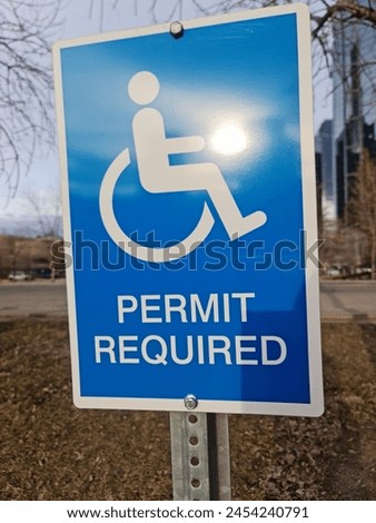 A blue handicapped parking sign
