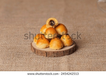 several pineapple cakes photographed with studio light, with a brown cloth background