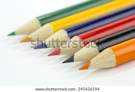 wooden color pencils on a white background closeup