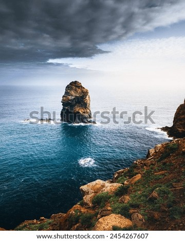 A Rocky Cliff With A Body Of Water In The Middle Of Ocean 