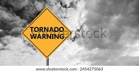 Hurricane Idalia warning sign against a powerful stormy background with copy space. Dirty and angled sign with cyclonic winds add to the drama.hurricane season sign on cloudy background Royalty-Free Stock Photo #2454275063