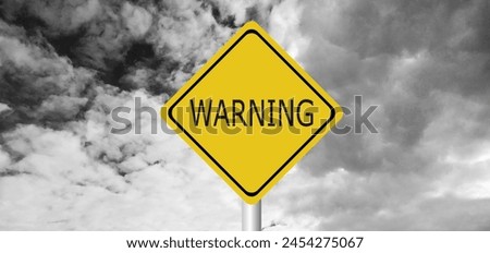Hurricane Idalia warning sign against a powerful stormy background with copy space. Dirty and angled sign with cyclonic winds add to the drama.hurricane season sign on cloudy background Royalty-Free Stock Photo #2454275067