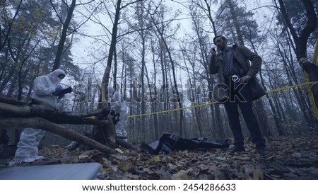 Investigation team examines a murder scene in the forest, focusing on crime evidence collection