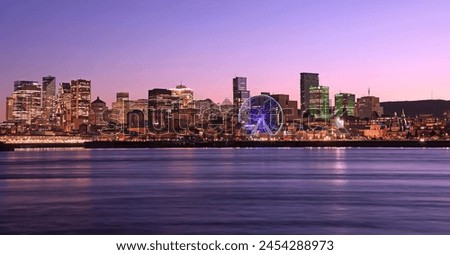 Montreal skyline at dusk with reflections in Saint Lawrence River, including newest skyscrapers in Quebec, Canada