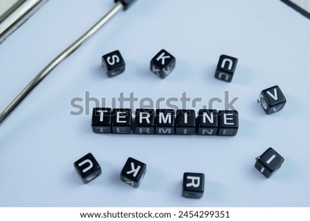Concept of Termine written on wooden blocks. Cross processed image on Wooden Background