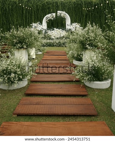Wedding decorations, garden party, wood stepping for the bride and groom to walk, left right sides are decorated with flowers, at the end are the final stage to take pictures, Indonesia, April 2024